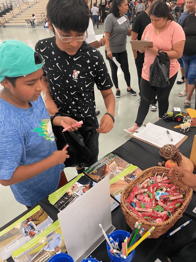 Youth engaging at a community outreach booth